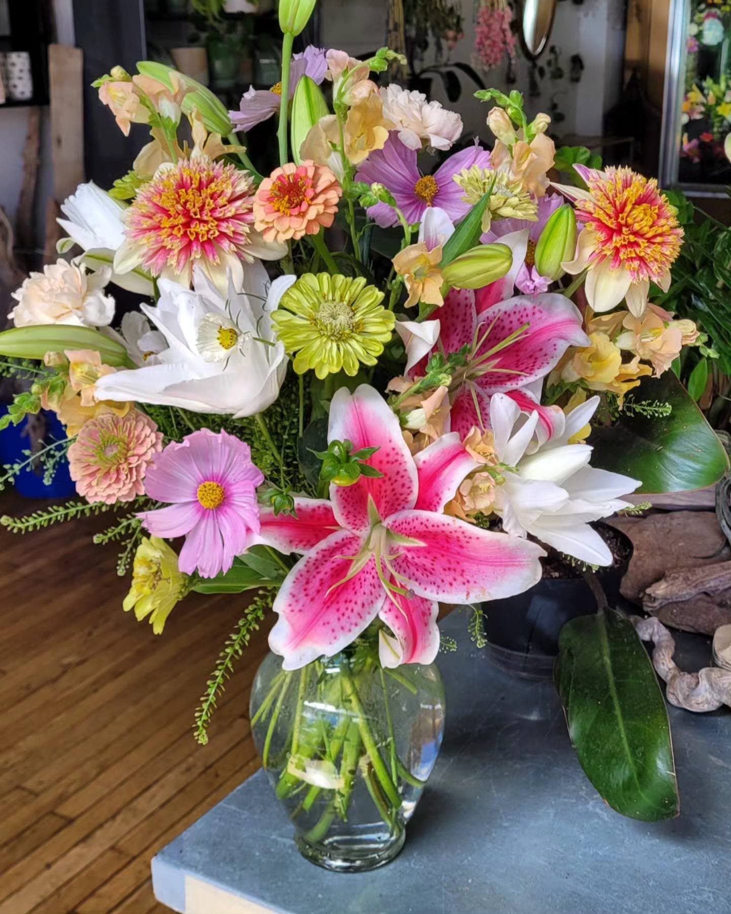 Pink, white, and green flowers in a vase on a table